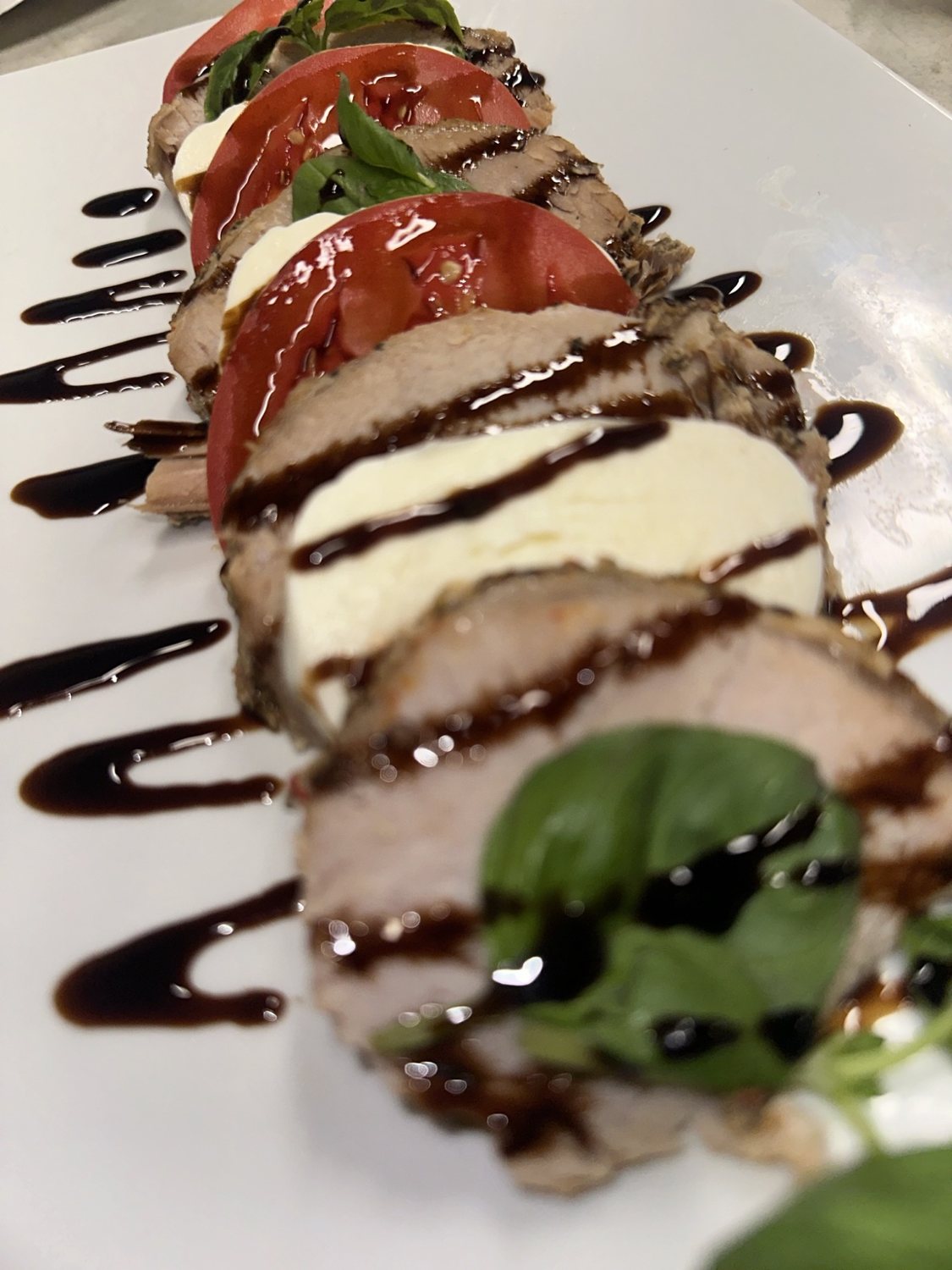 Tomato, mozzarella and basil with sliced meat and balsamic drizzle