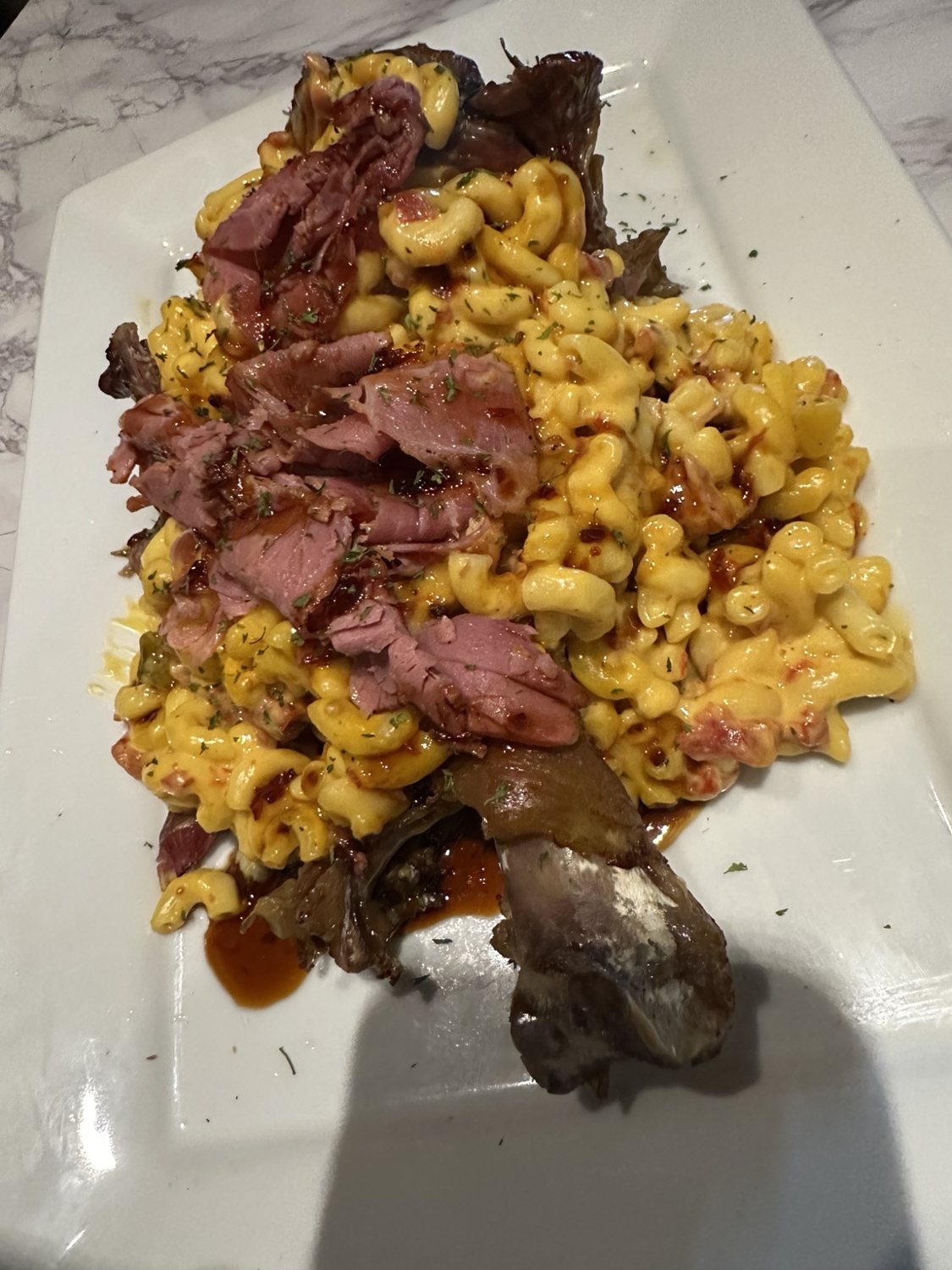 Loaded macaroni and cheese topped with smoked meat