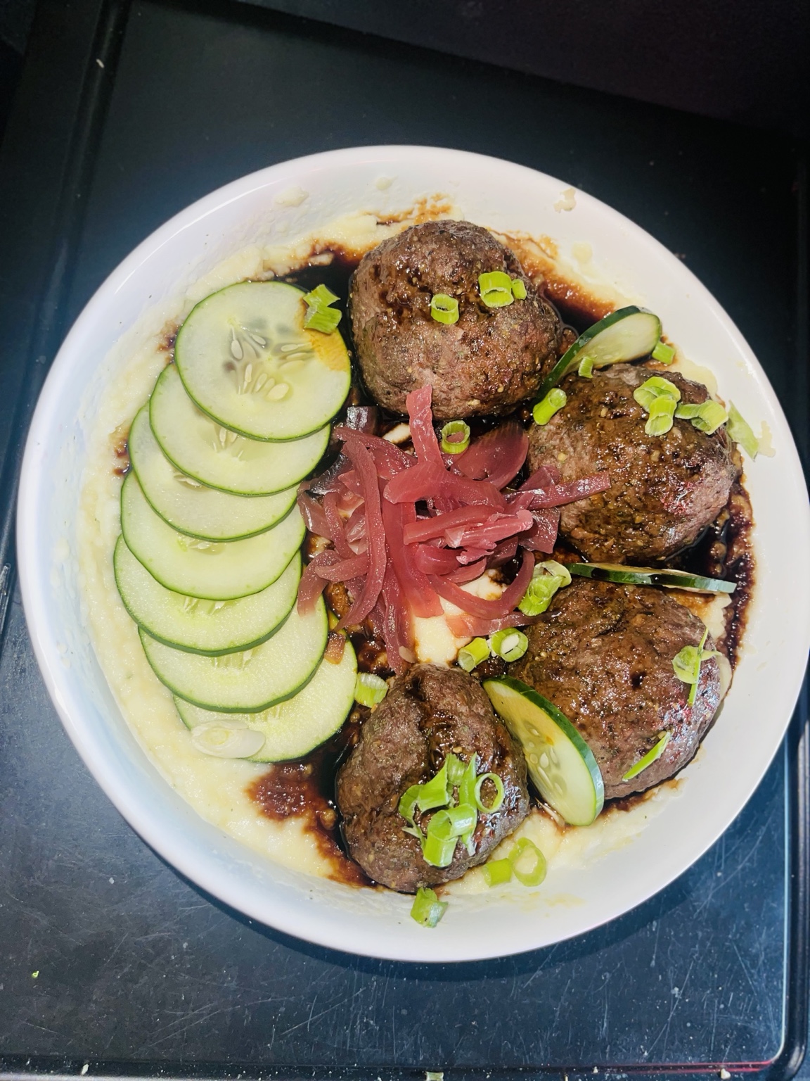 Glazed meatballs with cucumber, pickled onion and green onion